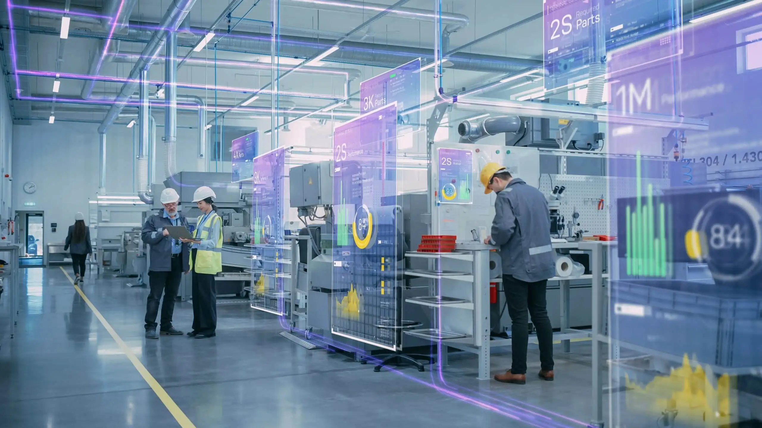 Photo en usine : deux personnes analysent les indicateurs de suivi de production sur un ordinateur